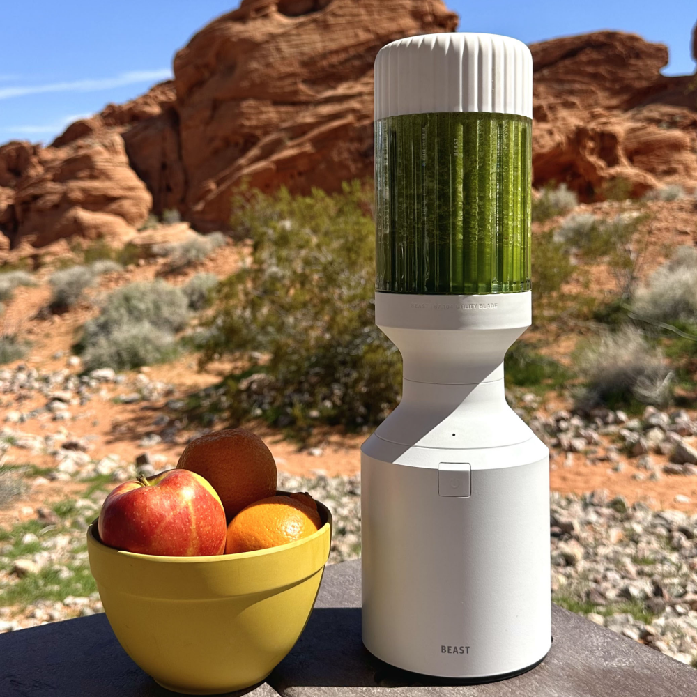 blender and apples on the background of mountains 