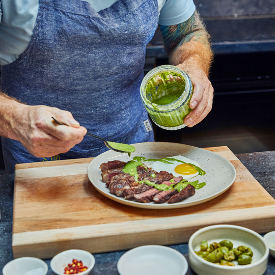 The chef decorates the dish with sauce